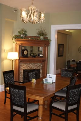Cozy dining area with a wooden table and chandelier