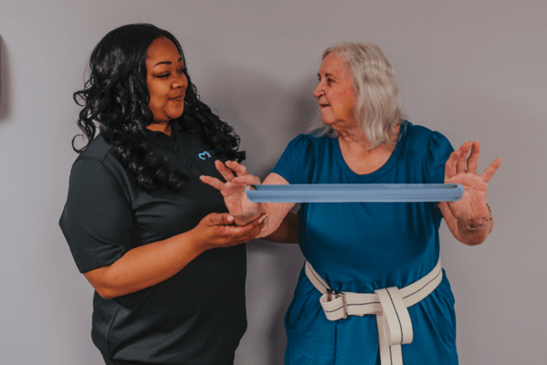 Staff member engaging with a resident during an activity