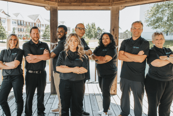 Staff members posing outdoors at the facility
