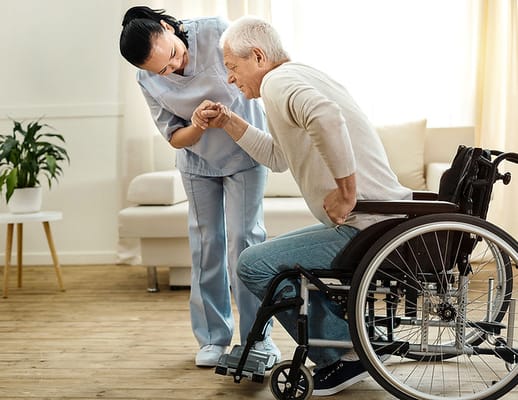 Caregiver assisting a resident in a bright living area