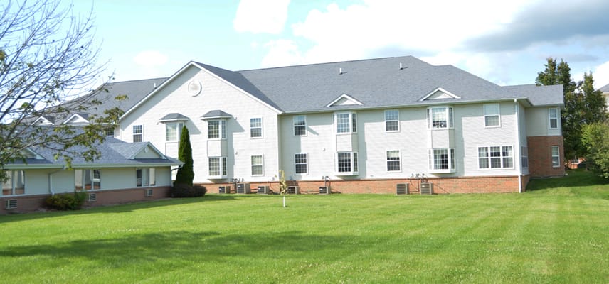 Exterior view of a senior living facility with lawns