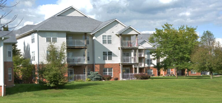 Exterior view of a senior living facility with landscaped grounds
