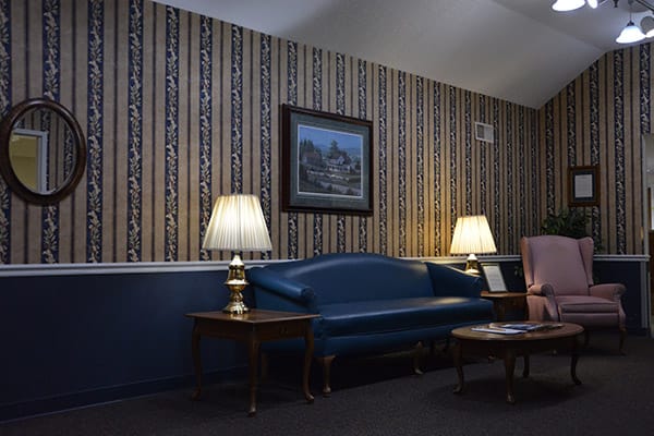 Cozy interior sitting area with a blue couch and lamps