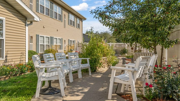 Outdoor seating area with chairs and flowers