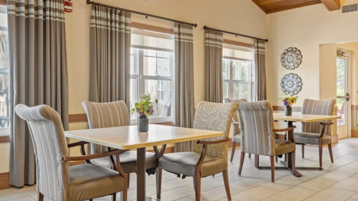Bright dining area with flower arrangements on tables