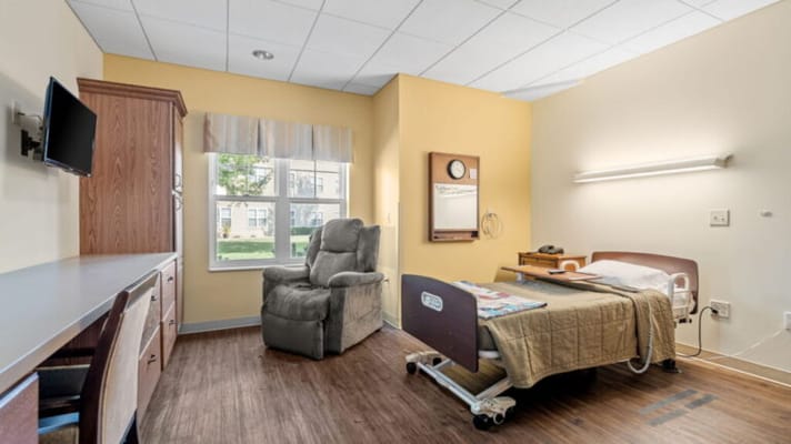 Private resident room with bed and chair