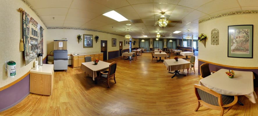 Dining area with tables and chairs in warm tones