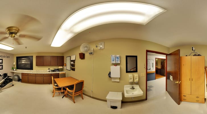 Panoramic view of a facility lounge area with a kitchenette