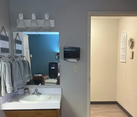 Bright bathroom area with towels and mirror
