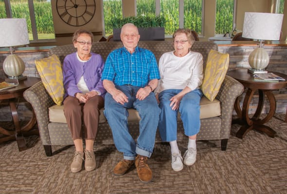 Three residents enjoying a cozy common area