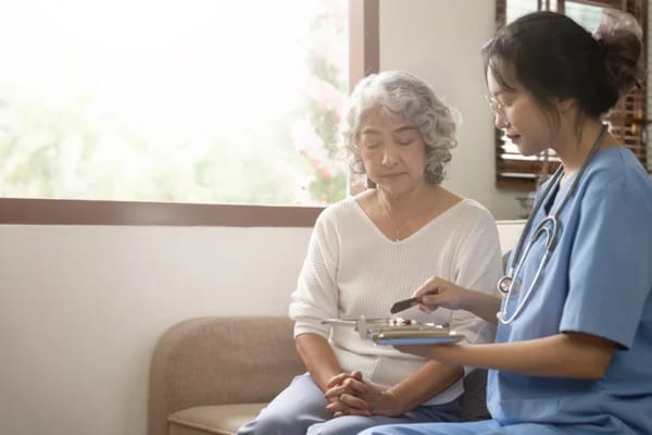 A caregiver consulting with a senior resident indoors