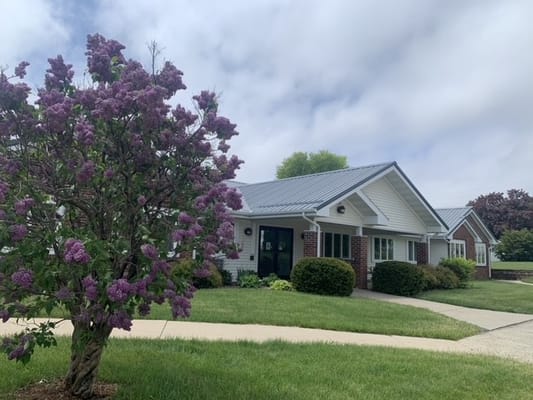 Exterior view of a senior living facility with flowers