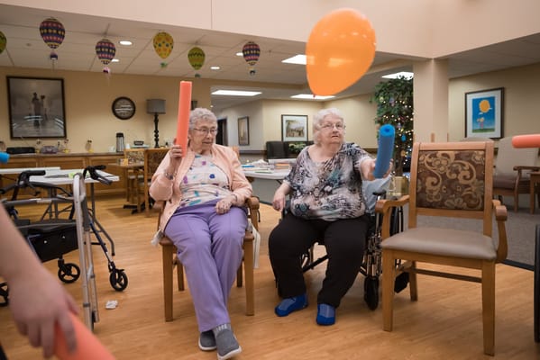 Residents engaging in a balloon activity indoors