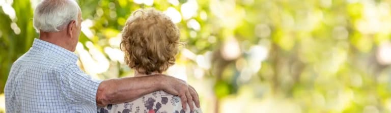 Couple embracing in a lush outdoor setting