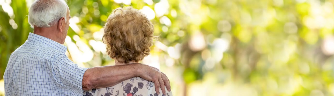 Couple embracing in a lush outdoor setting