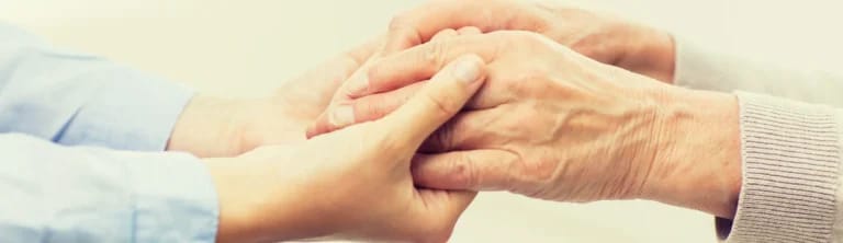Close-up of two hands, signifying care and connection