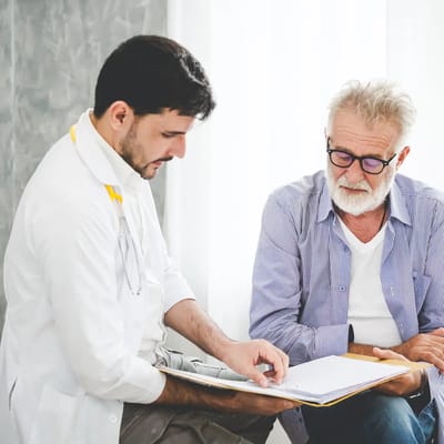 Doctor consulting with an elderly male patient