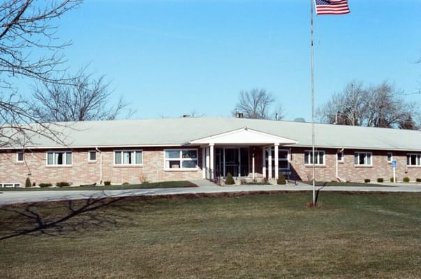 Exterior view of the assisted living facility with American flag