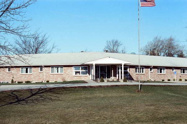 Exterior view of the assisted living facility with American flag