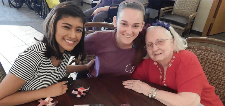 Residents and staff enjoying a puzzle activity together