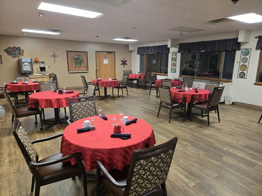 Dining room with red tablecloths and empty tables