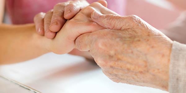 Close-up of hands held together, showing connection
