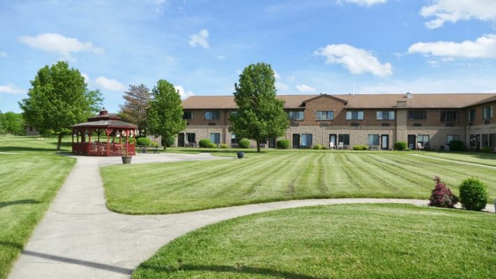 Well-maintained landscaped garden with a gazebo and building