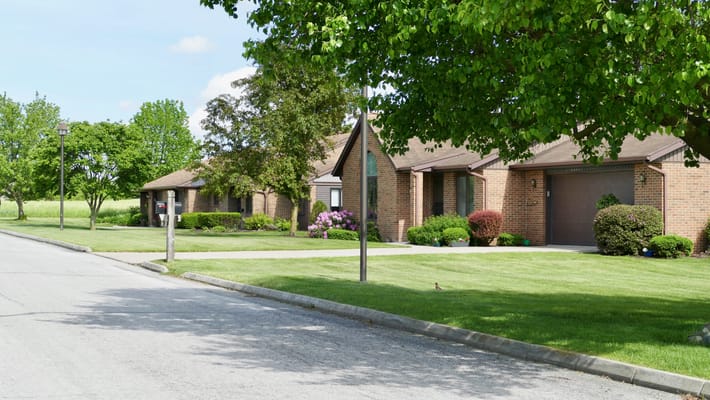 Exterior view of a senior living facility with landscaped gardens