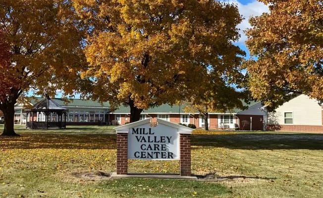 Exterior view of Mill Valley Care Center with colorful trees