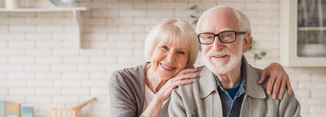 Smiling elderly couple in a cozy interior