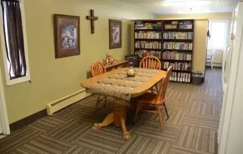 Interior common area with a table and bookshelves
