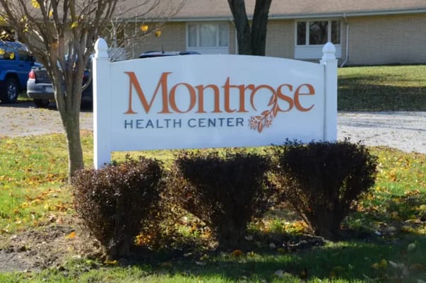 Exterior sign for Montrose Health Center surrounded by shrubs