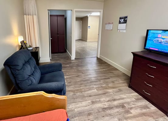 Cozy resident room with furniture and TV