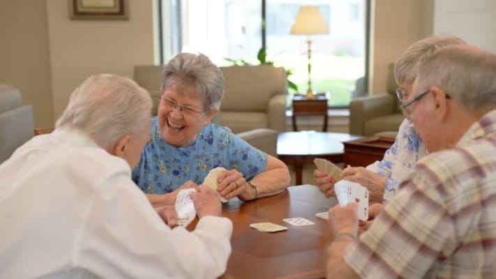 Residents enjoying a game of cards in a common area