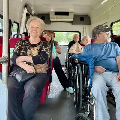 Residents on a facility transport van