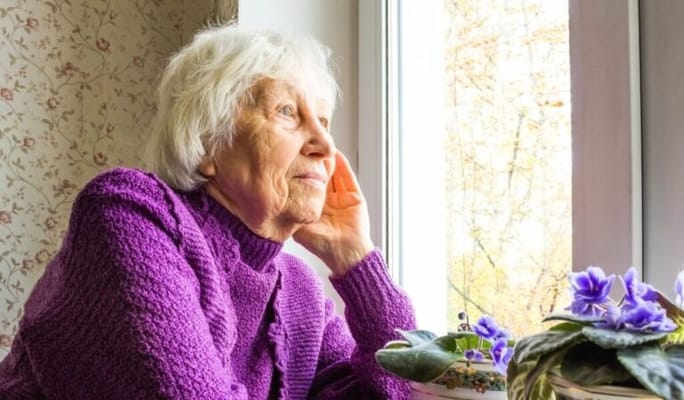Elderly woman gazing out the window