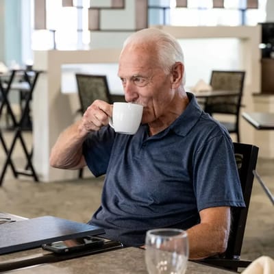 Senior man enjoying a cup of coffee in a dining area