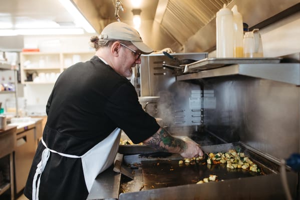 Staff member cooking in a kitchen