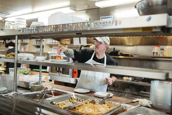 Chef plating food in a kitchen