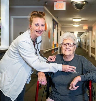 Nurse checking on a resident in the hallway