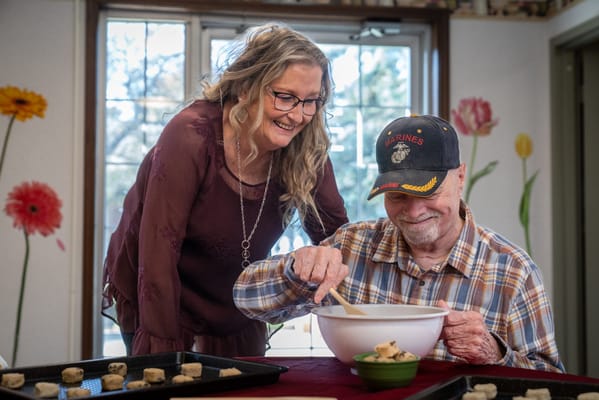 Residents and staff engaging in a baking activity