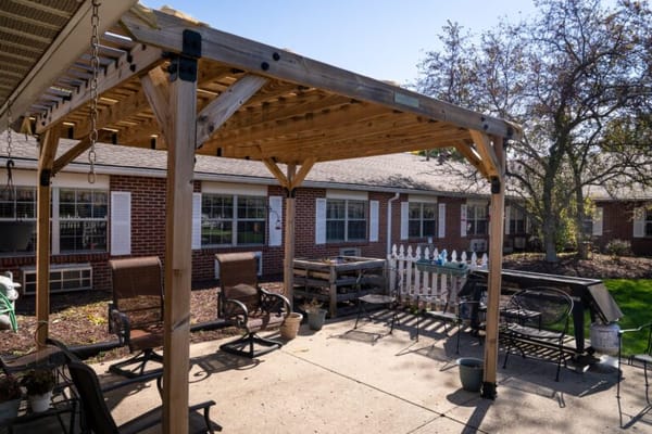 Outdoor patio area with seating and greenery