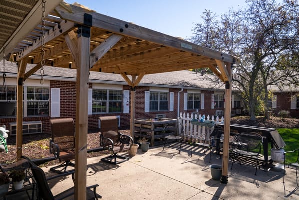 Outdoor patio area with seating and greenery