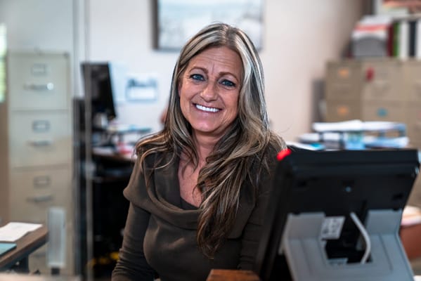 Staff member smiling at the front desk