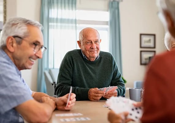 Residents playing cards in a communal space