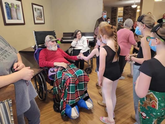 Residents enjoying a performance by young dancers