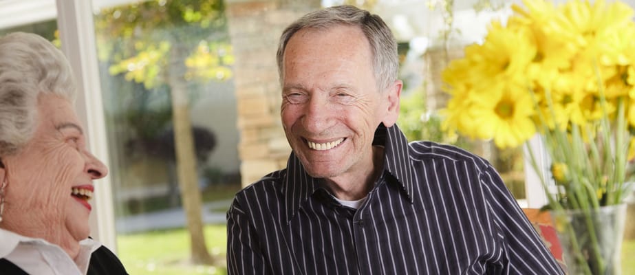Residents laughing together in a sunny common area