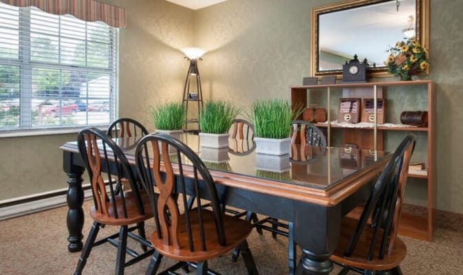 Cozy interior dining area with a large table and plants