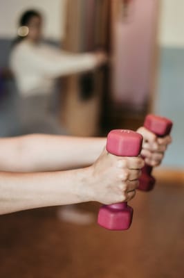 Residents exercising with weights in a fitness area