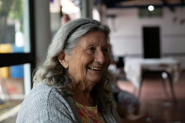 Smiling elderly woman in a cozy interior setting
